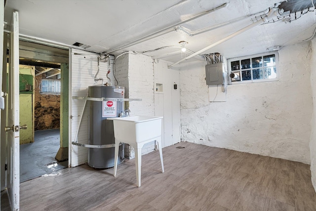 basement with strapped water heater and electric panel