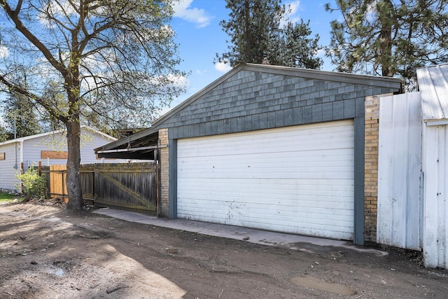 detached garage featuring fence