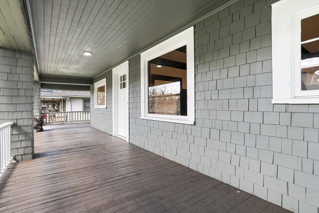 wooden terrace featuring covered porch