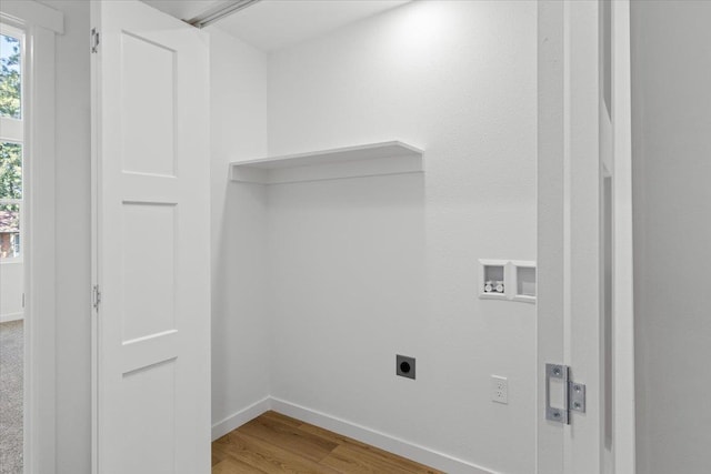 washroom with baseboards, washer hookup, hookup for an electric dryer, laundry area, and light wood-type flooring