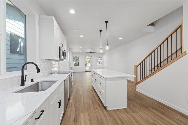 kitchen featuring a sink, light wood-style flooring, recessed lighting, and appliances with stainless steel finishes