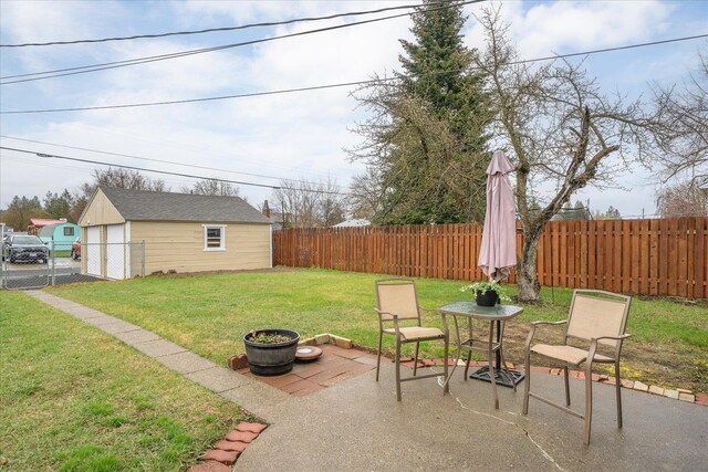 view of yard with a patio area, a garage, and a fenced backyard