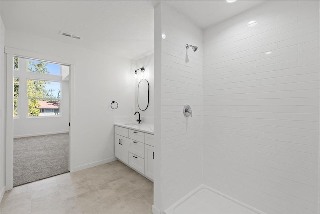 1920 E 37th Ave, Spokane, WA 99203 - full bathroom featuring vanity, baseboards, tiled shower, and visible vents