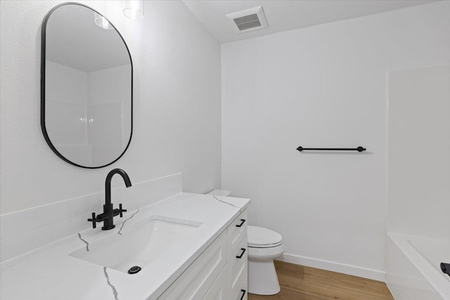1920 E 37th Ave, Spokane, WA 99203 - full bath featuring toilet, wood finished floors, vanity, visible vents, and a bath