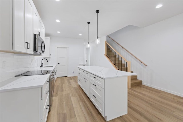 1920 E 37th Ave, Spokane, WA 99203 - kitchen with stainless steel microwave, a sink, light wood-type flooring, electric range, and recessed lighting
