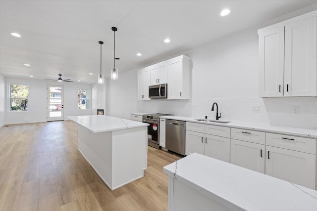 1920 E 37th Ave, Spokane, WA 99203 - kitchen featuring light wood-type flooring, stainless steel appliances, recessed lighting, and a sink