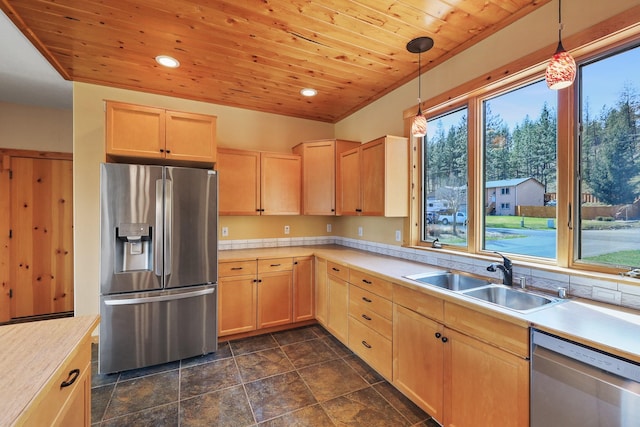 kitchen with light brown cabinets, light countertops, appliances with stainless steel finishes, wood ceiling, and a sink