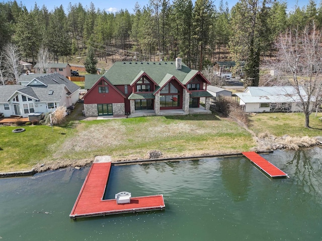 dock area with a water view and a lawn