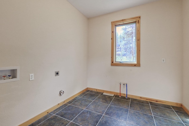 washroom with baseboards, dark tile patterned floors, laundry area, hookup for an electric dryer, and hookup for a washing machine