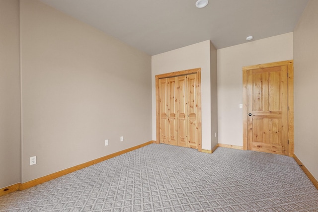 unfurnished bedroom featuring light colored carpet and baseboards