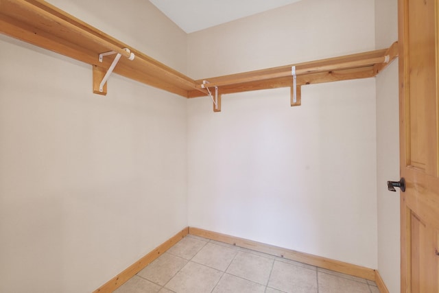 walk in closet featuring light tile patterned flooring