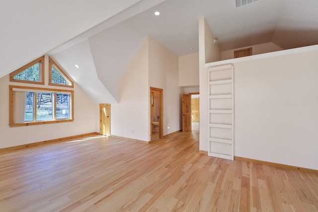 bonus room with high vaulted ceiling, light wood finished floors, baseboards, and visible vents