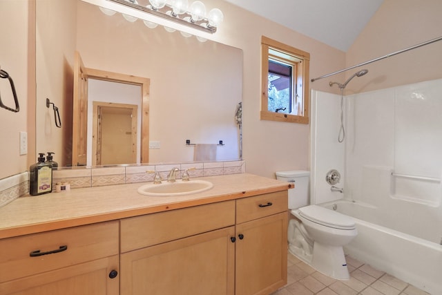 bathroom featuring vanity, vaulted ceiling, tile patterned floors, shower / bath combination, and toilet