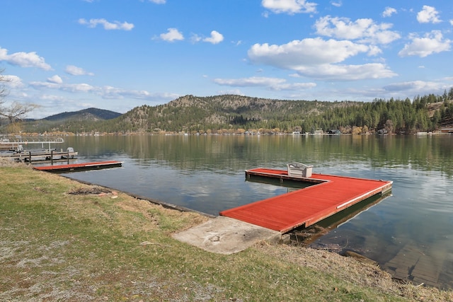 view of dock with a water and mountain view