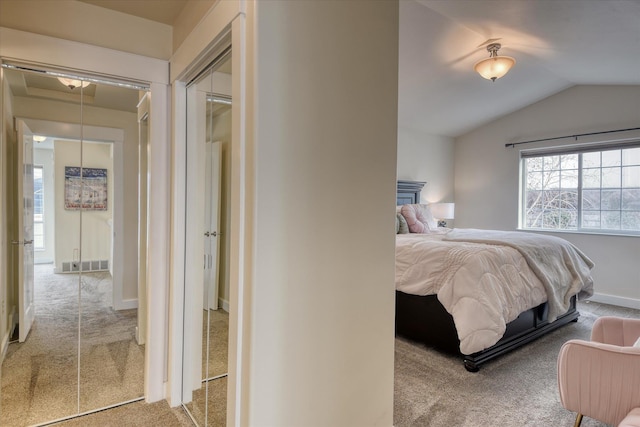 carpeted bedroom with visible vents, baseboards, and vaulted ceiling