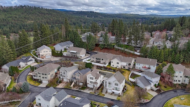 drone / aerial view with a forest view and a residential view