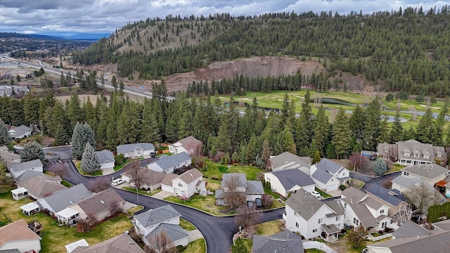 birds eye view of property with a view of trees and a residential view