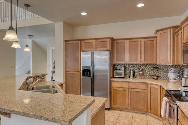 kitchen with light stone countertops, decorative backsplash, stainless steel appliances, a sink, and hanging light fixtures