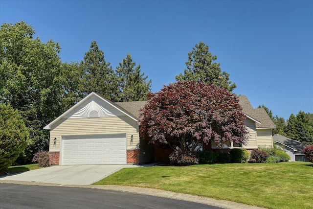4420 E 51st Ln, Spokane, WA 99223 - view of front of home featuring brick siding, an attached garage, concrete driveway, and a front yard