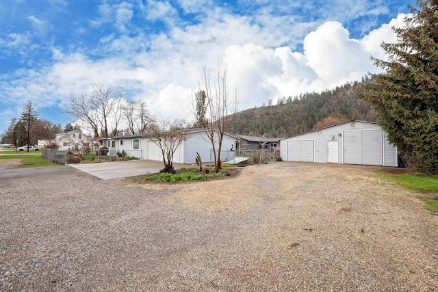 exterior space with a garage, driveway, and fence