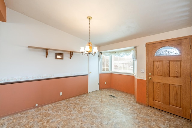 entryway with visible vents, tile patterned floors, an inviting chandelier, and vaulted ceiling
