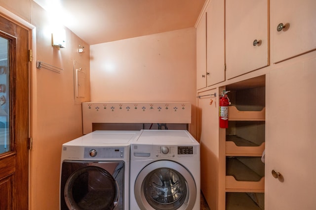 washroom with cabinet space and independent washer and dryer
