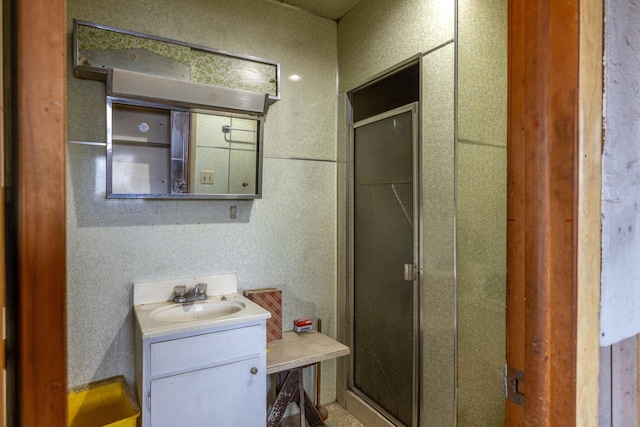 full bathroom with a stall shower and vanity
