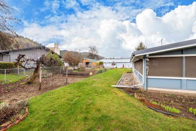 view of yard with a garden and fence