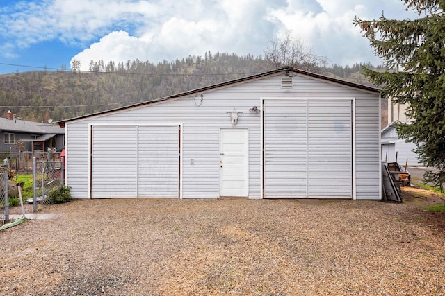detached garage featuring fence