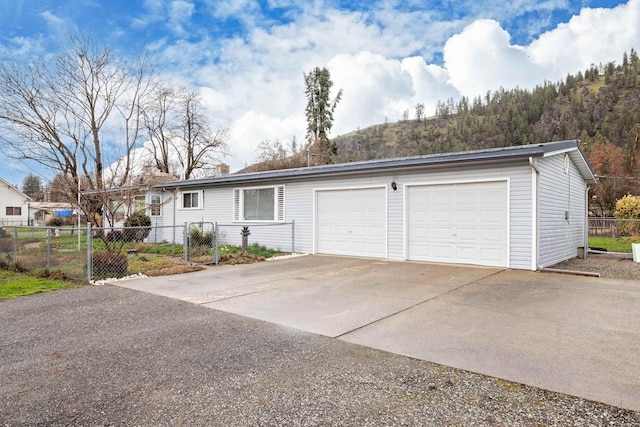 single story home with driveway and fence