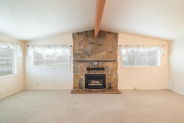 unfurnished living room featuring a stone fireplace, carpet flooring, lofted ceiling with beams, and baseboards