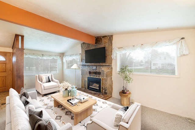 living area with a fireplace, carpet flooring, and lofted ceiling with beams
