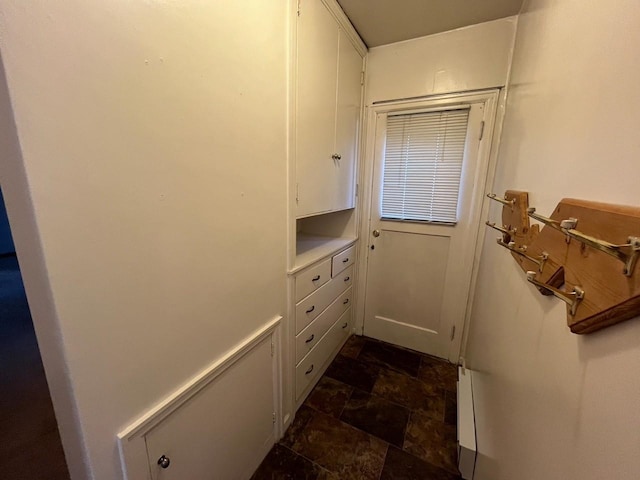 doorway featuring stone finish floor