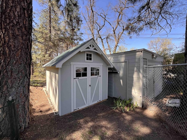 view of shed with fence