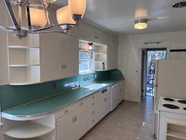 kitchen with white appliances, open shelves, and a sink