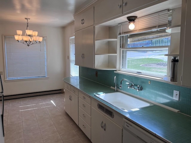 kitchen with tasteful backsplash, a chandelier, light tile patterned floors, dishwasher, and a sink