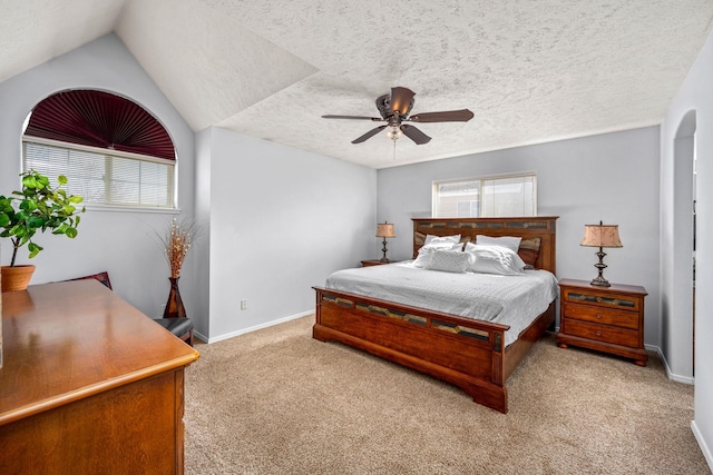 carpeted bedroom featuring baseboards, a textured ceiling, and ceiling fan