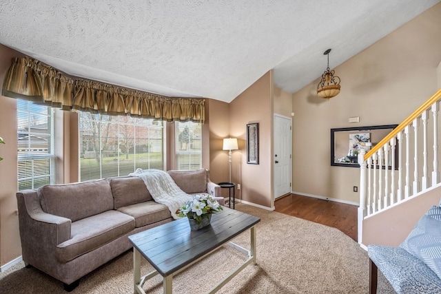 living room with plenty of natural light, carpet, baseboards, and lofted ceiling