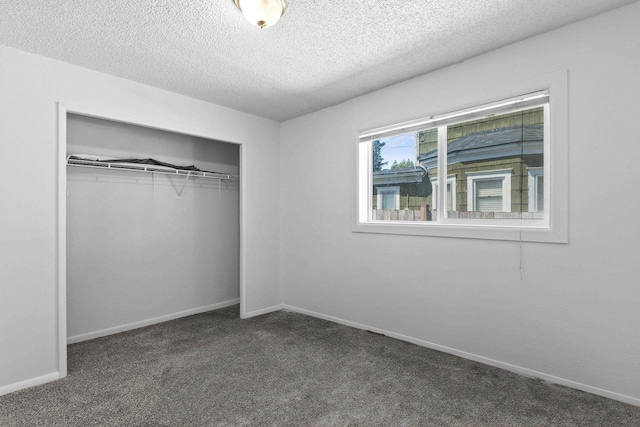 2218 E Hartson Ave, Spokane, WA 99202 - unfurnished bedroom with a textured ceiling, dark carpet, and a closet