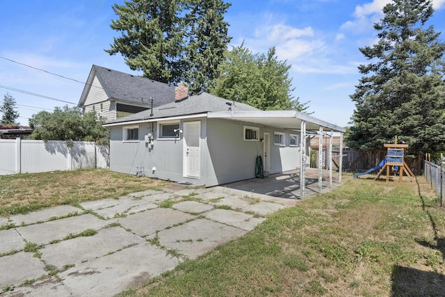 2218 E Hartson Ave, Spokane, WA 99202 - back of property featuring a fenced backyard, a playground, a patio, and a chimney