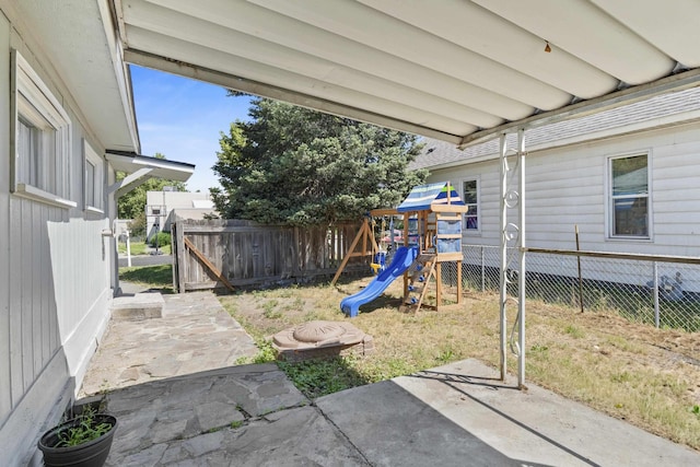 2218 E Hartson Ave, Spokane, WA 99202 - fenced backyard with a patio area and a playground