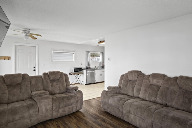 living room with light wood-type flooring and ceiling fan