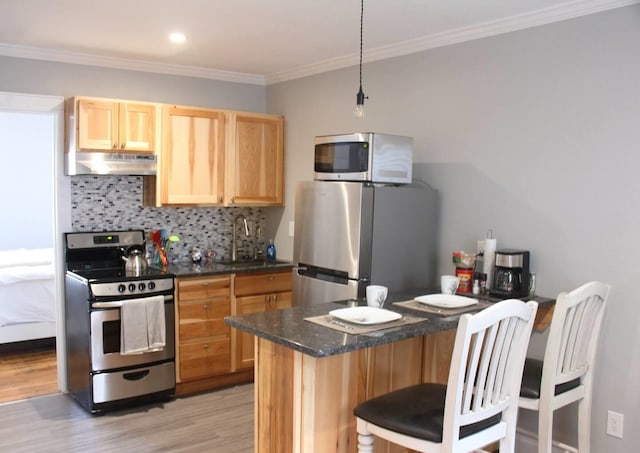 306 2nd St # 3 Id, Mullan, ID 83846 - kitchen with a sink, appliances with stainless steel finishes, light brown cabinetry, under cabinet range hood, and backsplash