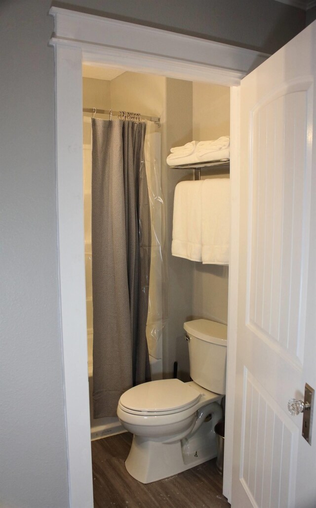 306 2nd St # 3 Id, Mullan, ID 83846 - bathroom with toilet, curtained shower, and wood finished floors
