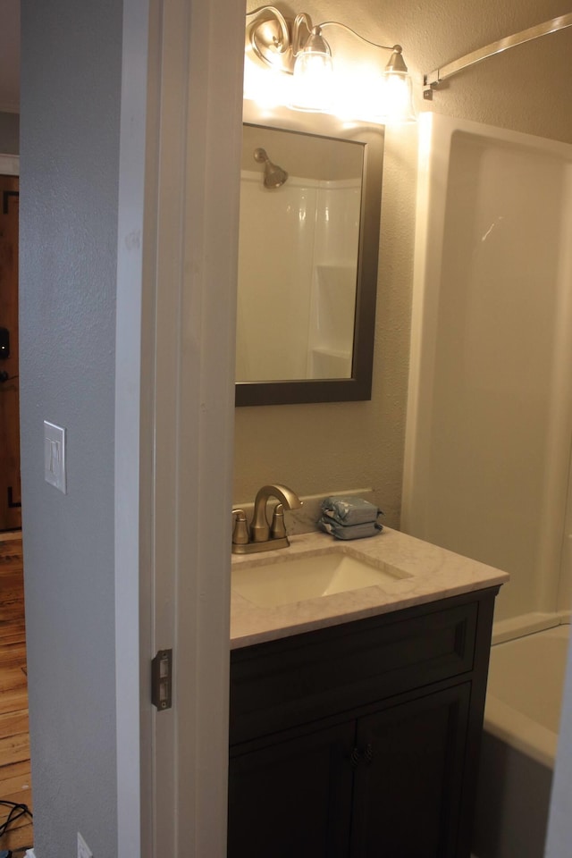 306 2nd St # 3 Id, Mullan, ID 83846 - bathroom with a shower, vanity, a textured wall, and a tub to relax in