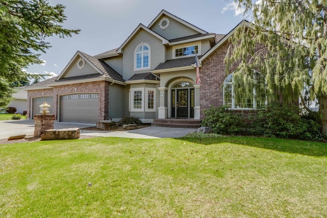 6519 W Kitsap Dr, Spokane, WA 99208 - view of front of home with a front lawn, driveway, a garage, and stucco siding