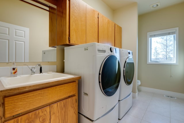 6519 W Kitsap Dr, Spokane, WA 99208 - clothes washing area with separate washer and dryer, laundry area, light tile patterned floors, a sink, and visible vents