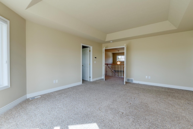 6519 W Kitsap Dr, Spokane, WA 99208 - unfurnished room featuring visible vents, a tray ceiling, and light carpet
