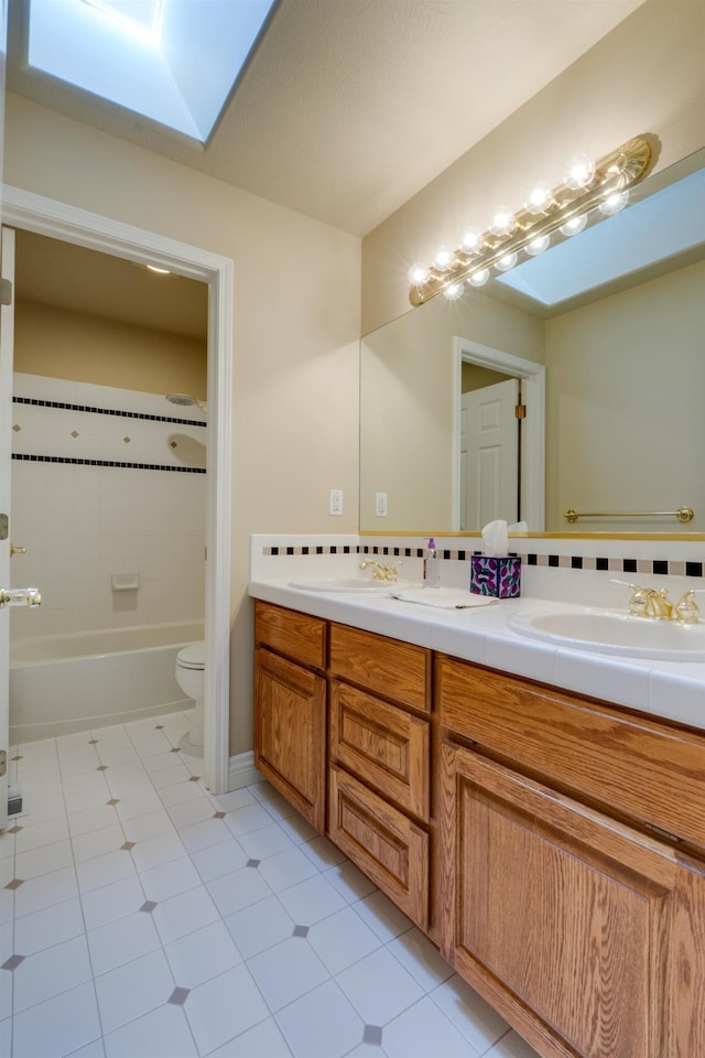 6519 W Kitsap Dr, Spokane, WA 99208 - bathroom featuring tile patterned flooring, a skylight, a sink, and double vanity