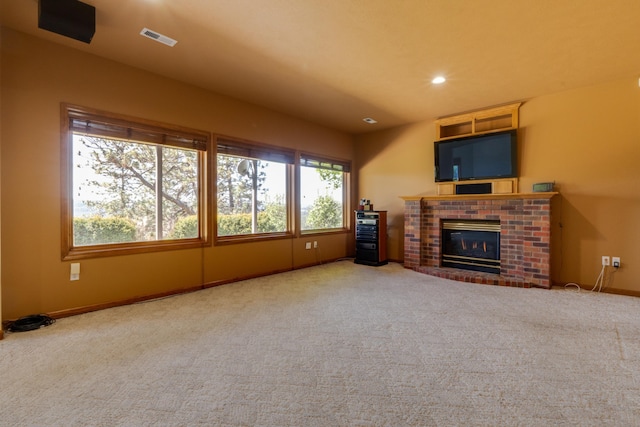 6519 W Kitsap Dr, Spokane, WA 99208 - unfurnished living room featuring carpet flooring, visible vents, baseboards, recessed lighting, and a fireplace